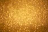 A blurred image of shining gold glitter.