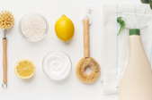 natural cleaning products like lemon and baking soda with spray bottle and scrub brush