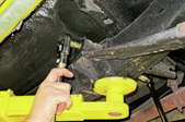 person tightening or removing a leaf spring