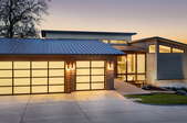 Home with garage lit up inside and out