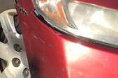 scratched bumper on a red car