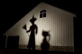 Creepy shadows projected onto the side of a house.