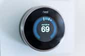 Nest thermostat on wall set to 69 degrees