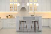 All white kitchen with small eating island