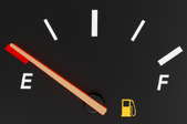 An empty gas gauge with the fuel light on.