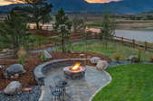 landscaped yard with fire pit area