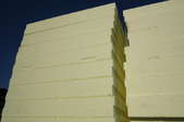 Two adjacent stacks of rigid foam board insulation.