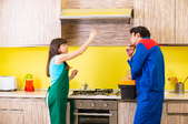 two people discussing a kitchen exhaust fan