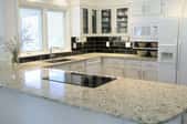 Granite countertop in a white kitchen.
