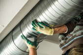 An inspection worker holding a duct. 