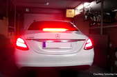 white car with tail and brake light illuminated