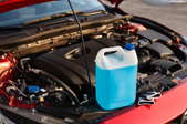 gallon of antifreeze on a car engine