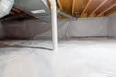 a crawl space with insulation and water barriers