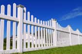 A white vinyl fence. 