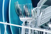a dishwasher rack with plates and silverware