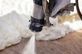 spray gun applying foam insulation