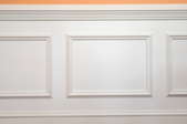 wainscotting panels on a peach colored wall
