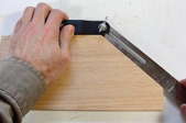 hands using a bevel on wood