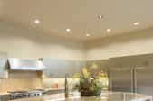 A kitchen with recessed lighting.