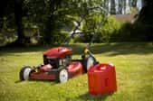 lawn mower and gas can on the grass