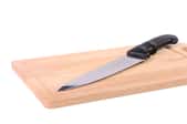 A butcher block with a knife on it. 
