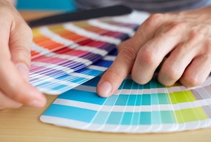 A selection of paint chips in a rainbow of colors.