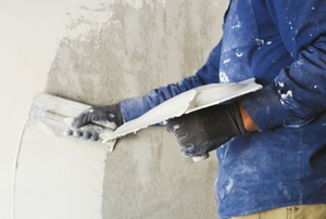 applying plaster to a wall
