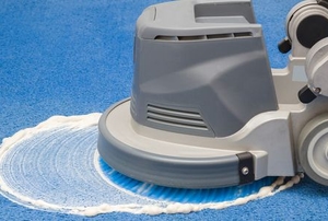 carpet cleaning machine applying soap to blue carpet