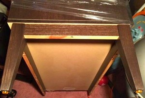 A Crate & Barrel china hutch with the legs broken off.
