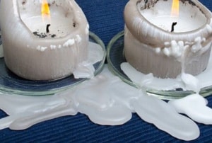 two candles melting onto a piece of fabric