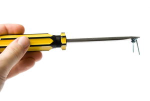 A magnetic screwdriver with screws attached to the end. 