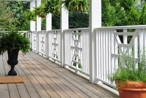 porch with hanging ferns and white railing