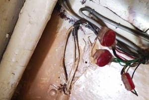 old mystery wires on a wall near a pipe