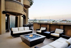 A fire pit on the patio of a luxurious home.