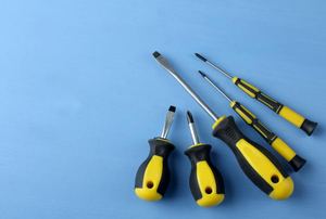 A set of screwdrivers against a blue background.