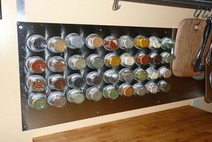 A magnetic spice rack in a kitchen.