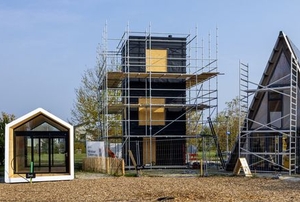 three different tiny homes under construction