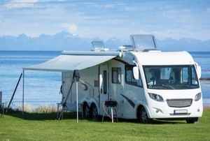 an RV with a tent set up against it