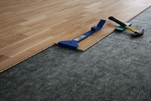 Underlayment with tools and wood flooring.