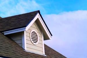 An attic vent with a louvered cover.