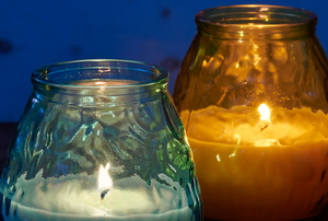 Two citronella candles in glass holders