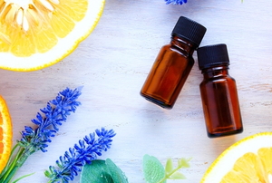 essential oils with lemons, oranges, and lavender flowers