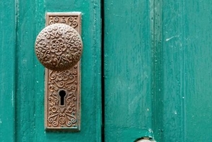 closeup of a teal door with doorknob