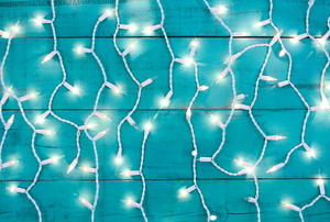 White Christmas lights against a blue background.