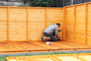 A man builds a shed.