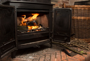 wood stove with fire on brick hearth