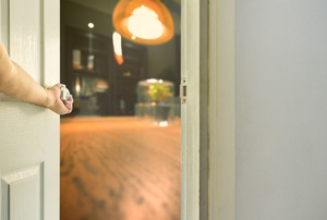an arm opening a door