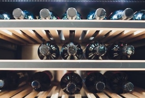 wine bottles in an upcycled refrigerator wine cellar