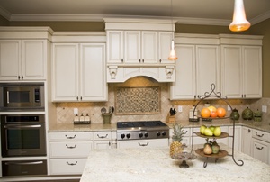 A kitchen with white cabinets.