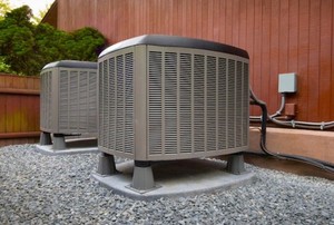 two air conditioning units on the side of a building